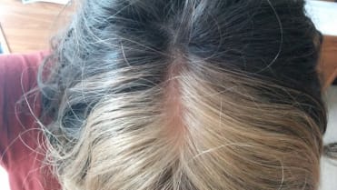 Žena má přirozeně blond i hnědé vlasy, perfektně oddělené Žena má přirozeně blond i hnědé vlasy, perfektně oddělené